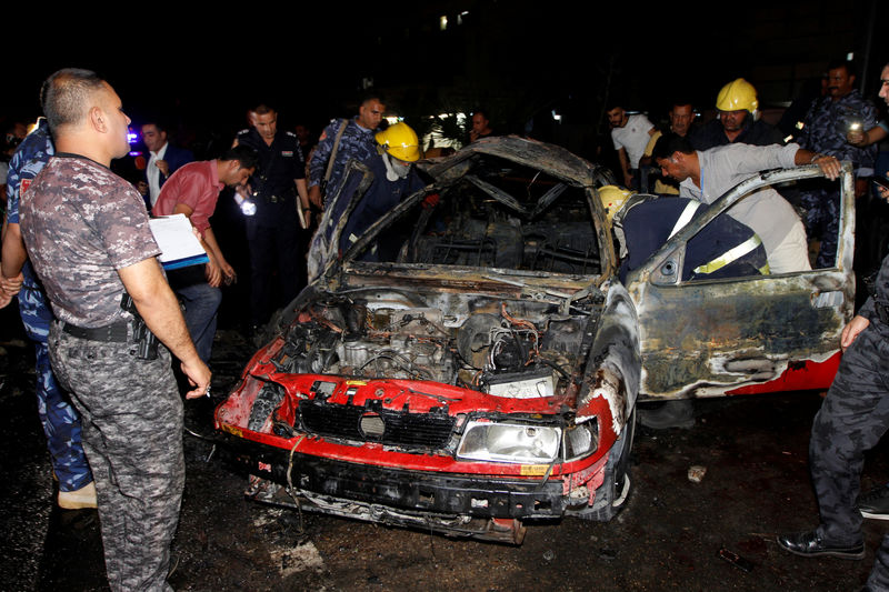 © Reuters. Iraqi security force  inspect the site after a car exploded in Kirkuk