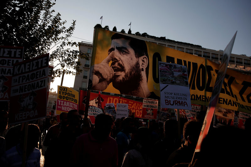 © Reuters. Protesters hold a banner depicting Greek late anti-fascist rapper Pavlos Fyssas during a rally marking four years since the fatal stabbing of Fyssas by a supporter of the ultranationalist Golden Dawn party in Athens