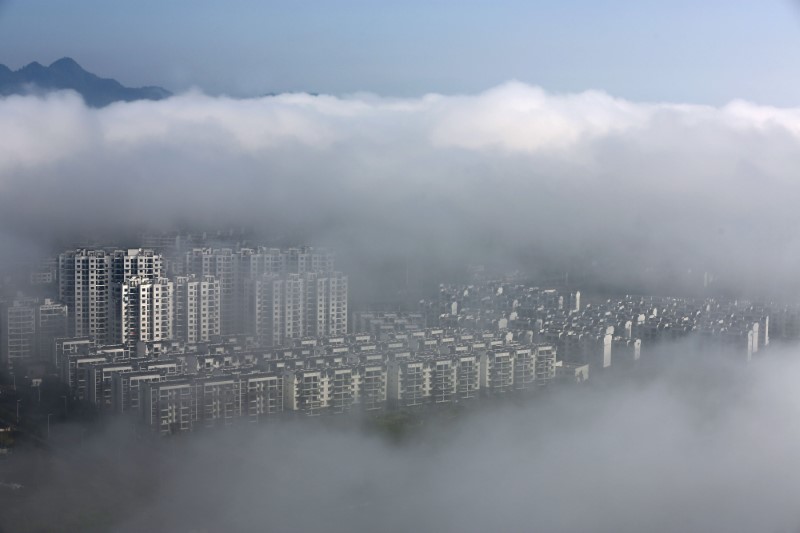 © Reuters. Residential buildings are seen after rain in Huangshan