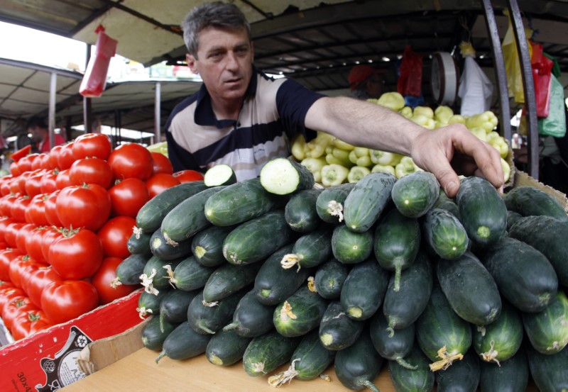 © Reuters. A vendor sells vegetables at a market in central Belgrade
