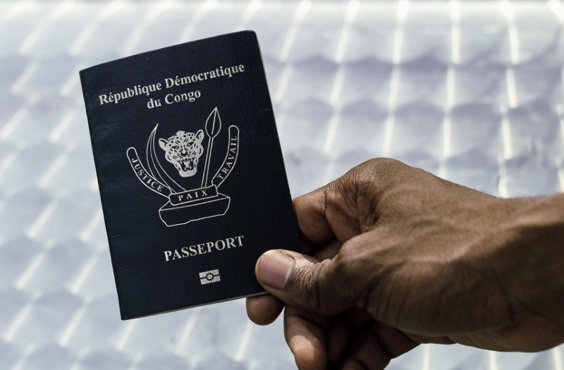 © Reuters. An immigration official displays a Congolese biometric passport in the Democratic Republic of Congo's capital Kinshasa