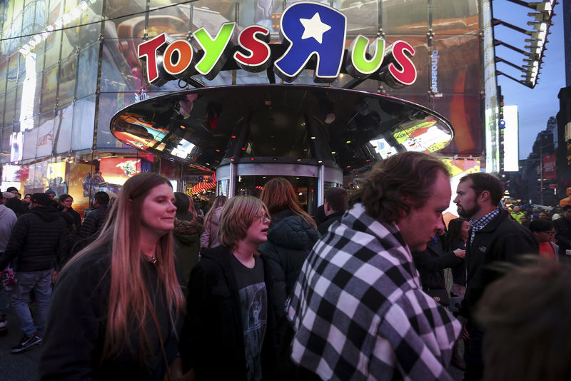 © Reuters. FILE PHOTO:    People walk past Toys R Us in Times Square the day after Christmas in the Manhattan borough of New York