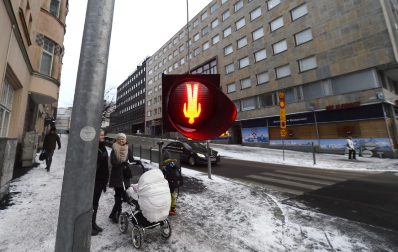 © Reuters. People walk in downtown Helsinki