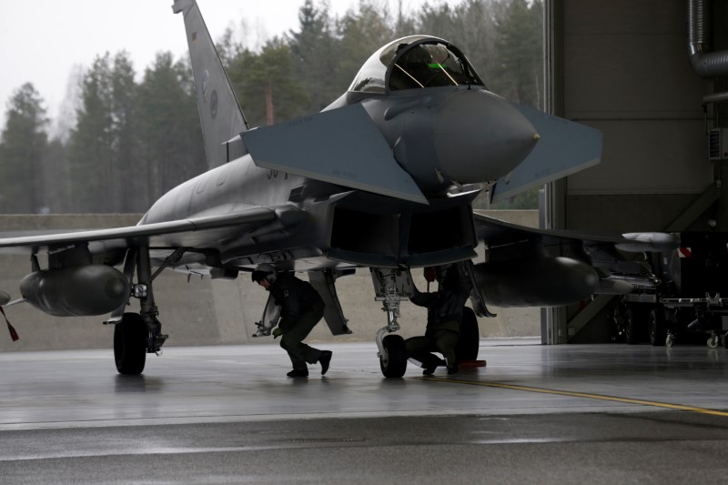 © Reuters. German Air Force technicians inspect Eurofighter Typhoon during the air policing scramble in Amari air base