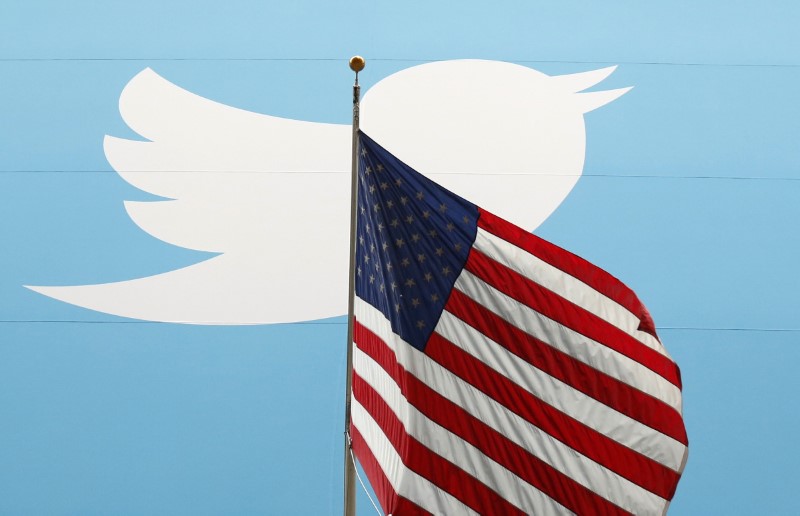 © Reuters. The Twitter Inc. logo is shown with the U.S. flag during the company's IPO on the floor of the New York Stock Exchange in New York