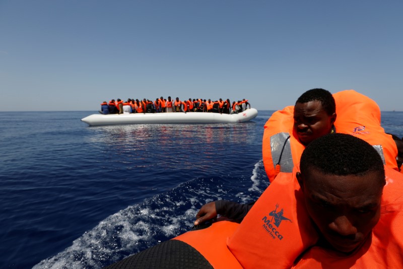 © Reuters. Migrants react after being rescued by the Malta-based NGO Migrant Offshore Aid Station ship Phoenix during a rescue operation in the central Mediterranean off the Libyan coastal town of Sabratha