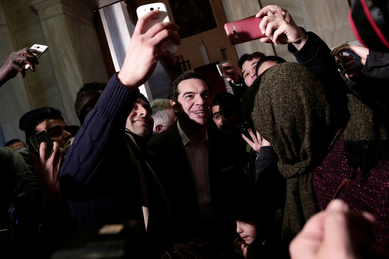 © Reuters. FILE PHOTO: Greek PM Tsipras takes selfies with refugee families and unaccompanied refugee minors at the parliament building in Athens