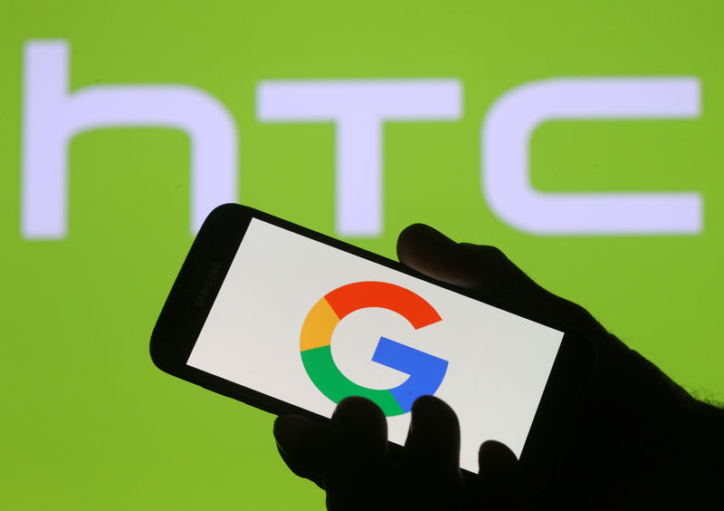 © Reuters. The Google logo is seen on a smartphone in front of a displayed HTC logo in this illustration