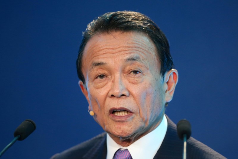 © Reuters. FILE PHOTO: Taro Aso speaks during the Milken Institute Global Conference in Beverly Hills