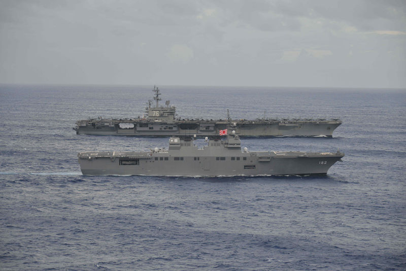 © Reuters. USS Ronald Reagan sails with Japan Maritime Self-Defense Force destroyer Ise during their joint military drill in the sea off Japan