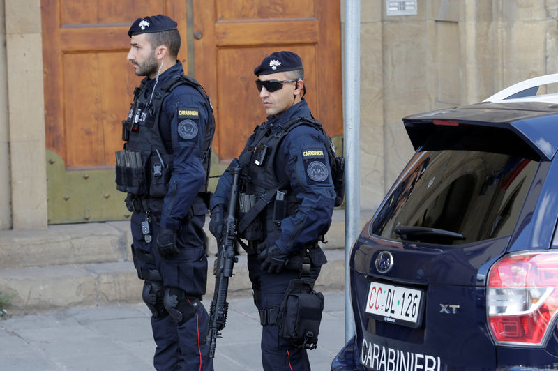 © Reuters. Armed police officers stand on duty ahead of a speech by Britain's Prime Minister Theresa May in Florence