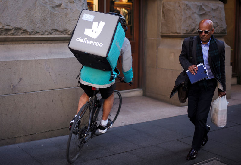 © Reuters. A rider for food delivery company Deliveroo cycles down a sidewalk in Sydney