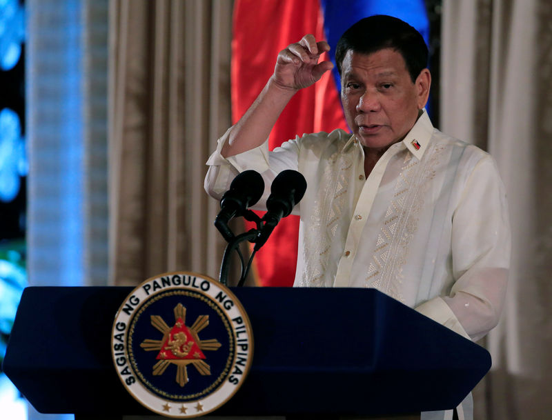 © Reuters. Duterte gestures as he delivers his speech during the oath taking of PNP star rank officers in Manila