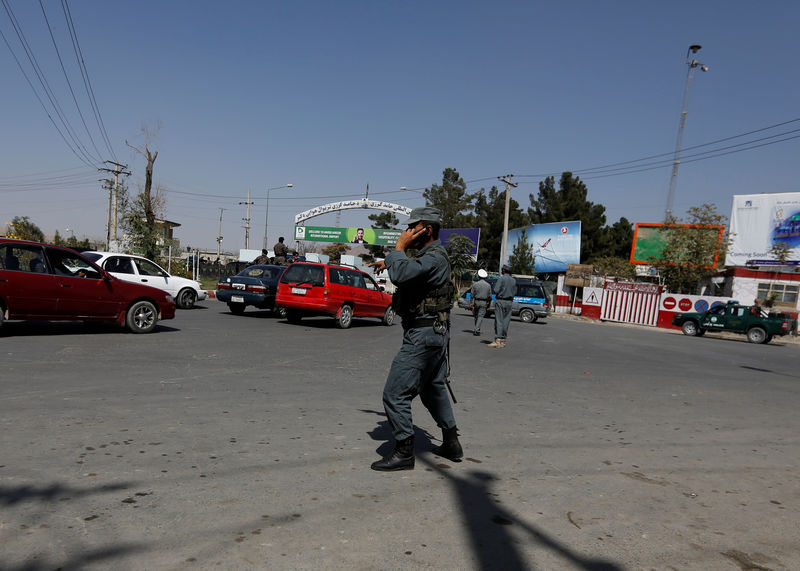 © Reuters. Afghan policemen stand guard outside of Kabul Airport after rockets exploded in Kabul, Afghanistan