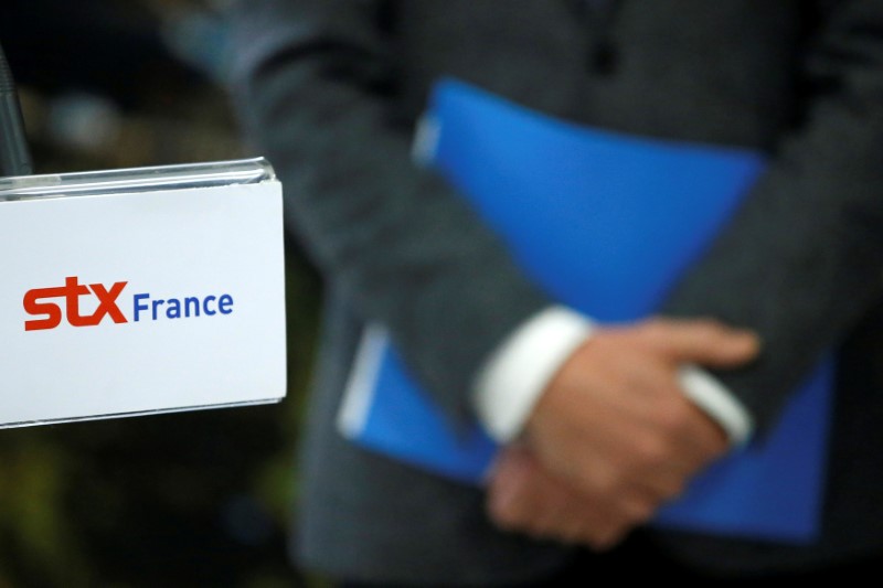 © Reuters. FILE PHOTO: The logo of STX is seen during a press conference at the STX Les Chantiers de l'Atlantique shipyard site in Saint-Nazaire