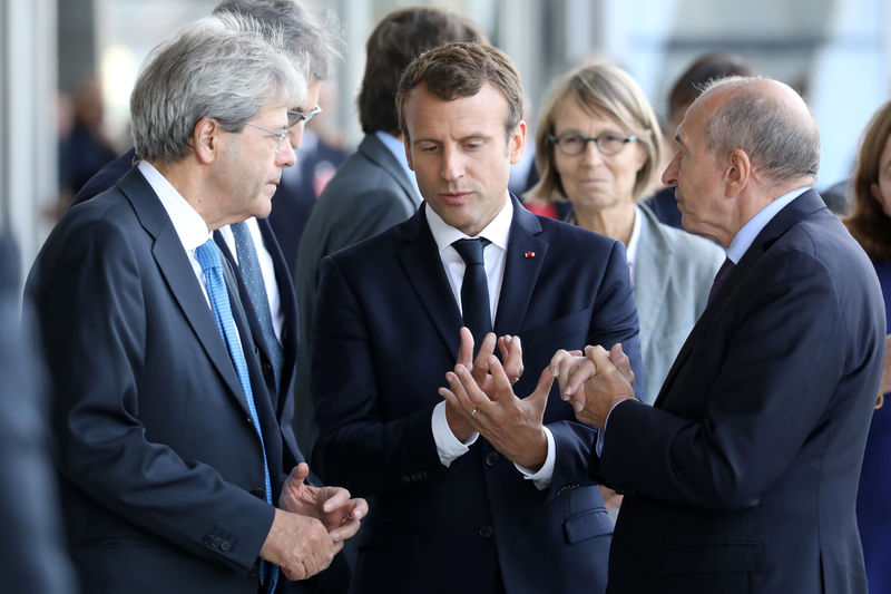 © Reuters. French President Emmanuel Macron, French Interior Minister Gerard Collomb and Italian Prime Minister Paolo Gentiloni arrive at the Confluences Museum as part of the 34th Franco-Italian summit in Lyon