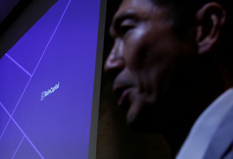 © Reuters. Logo of the Bain Capital is screened next to Managing Director Yuji Sugimoto at a news conference in Tokyo