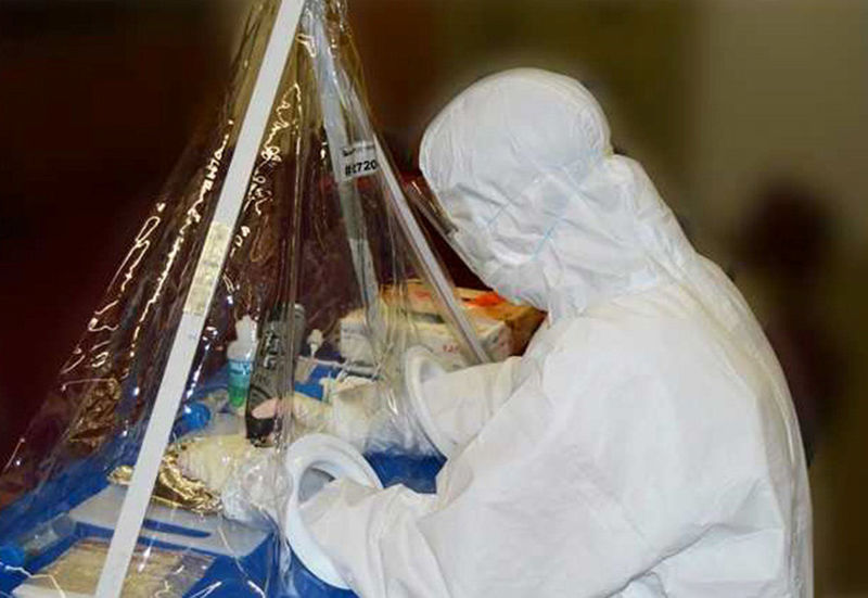 © Reuters. Dr. Malmström conducting on-site sampling of bone material in a mobile sampling lab pictured in this handout photo