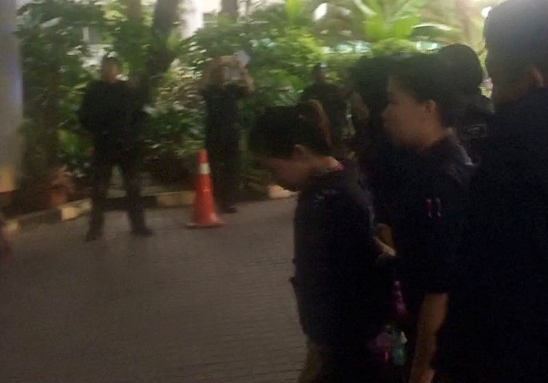 © Reuters. Video grab of Indonesian Siti Aisyah, who is accused of killing Kim Jong Nam, being escorted by police as she arrives at at the Shah Alam High Court on the outskirts of Kuala Lumpur