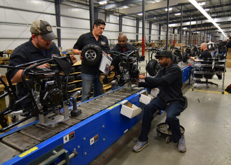 © Reuters. Workers construct mini-bikes at motorcycle and go-kart maker Monster Moto in Ruston