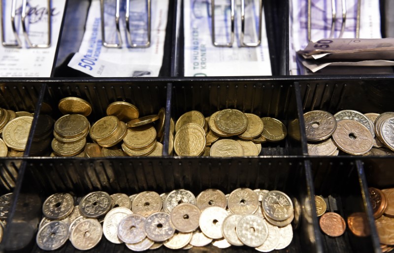 © Reuters. Coins in a cash-box of Danish crowns are pictured in a pub in Copenhagen