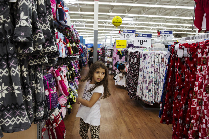 © Reuters. FILE PHOTO: A girl looks at pajamas while shopping at a Walmart store in Secaucus, New Jersey