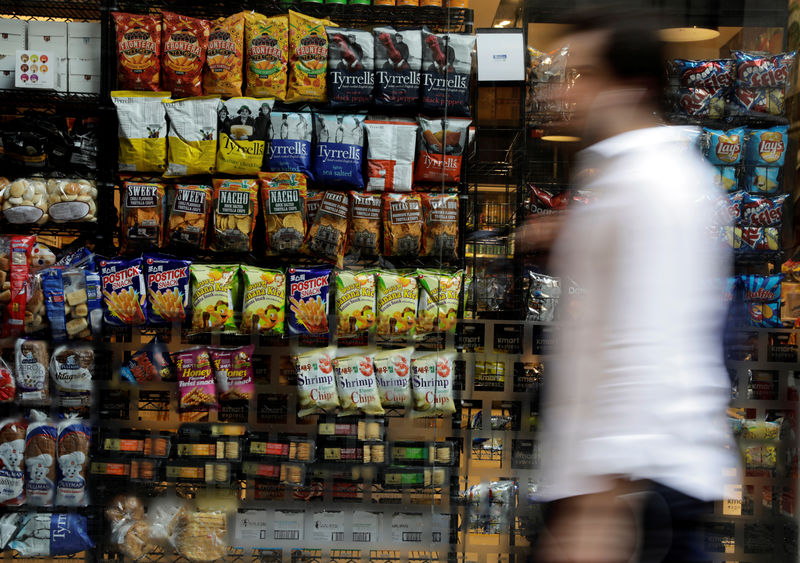 © Reuters. A man walks past a snacks store in downtown Sao Paulo