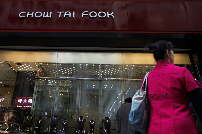 © Reuters. FILE PHOTO: Woman walks past a Chow Tai Fook Jewellery store in Hong Kong