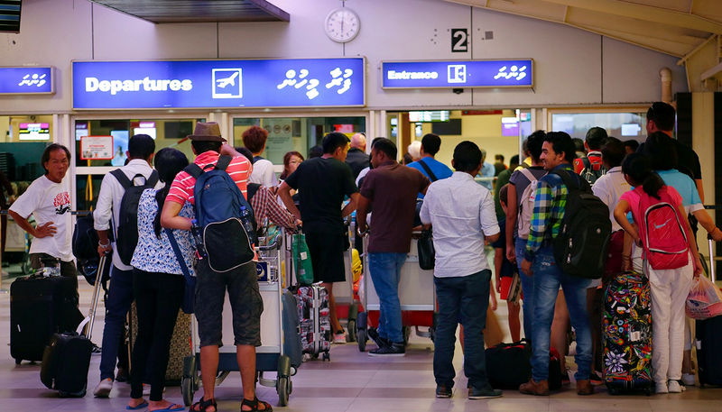 © Reuters. Tourists wait in the departures hall at Velana International Airport in Male