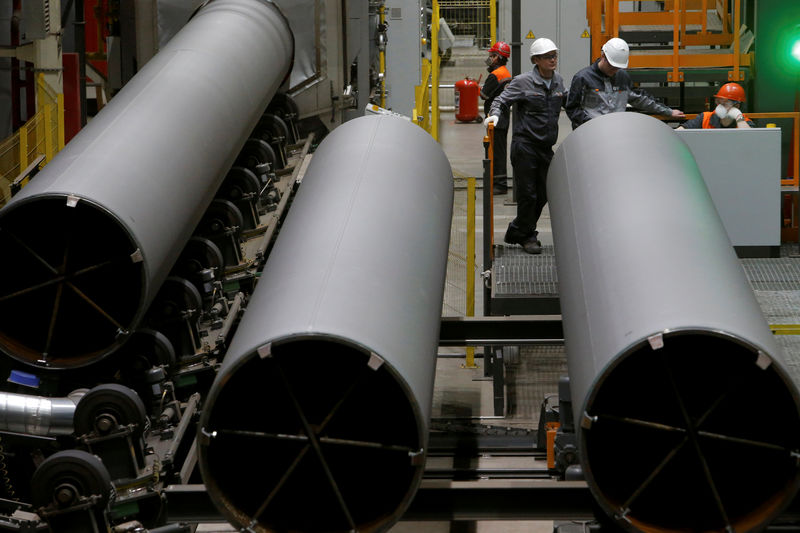 © Reuters. FILE PHOTO: Men are seen at work at Zagorsk Pipe Plant, which launched the production of large-diameter pipes for Gazprom, outside Moscow