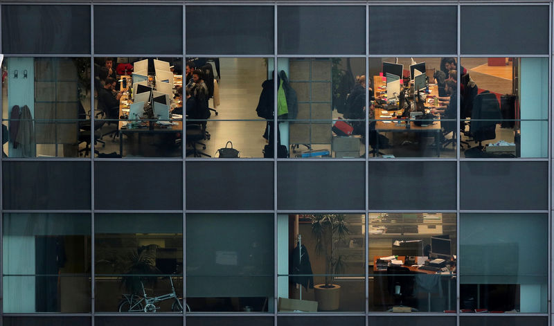 © Reuters. People work in offices in a building of Barcelona city
