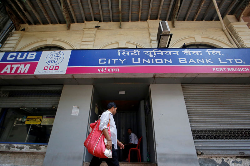 © Reuters. A man walks past a City Union Bank branch in Mumbai