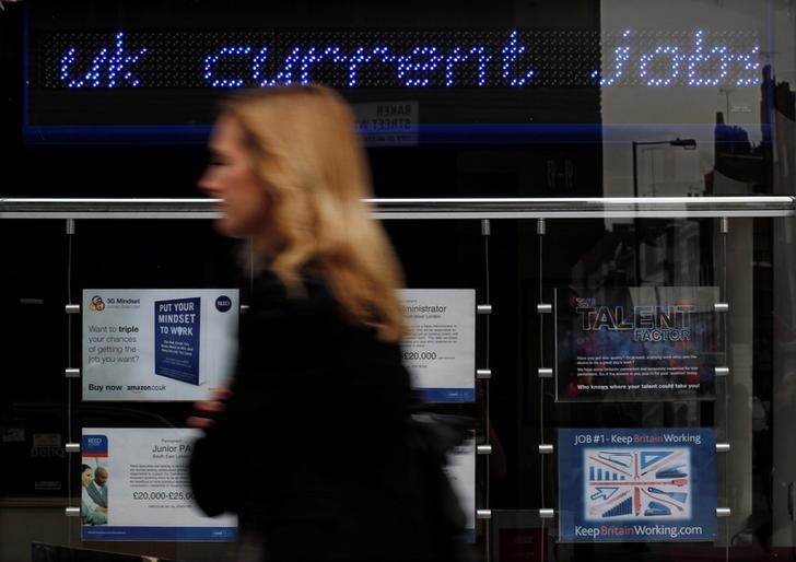 © Reuters. A pedestrian walks past an employment centre in London