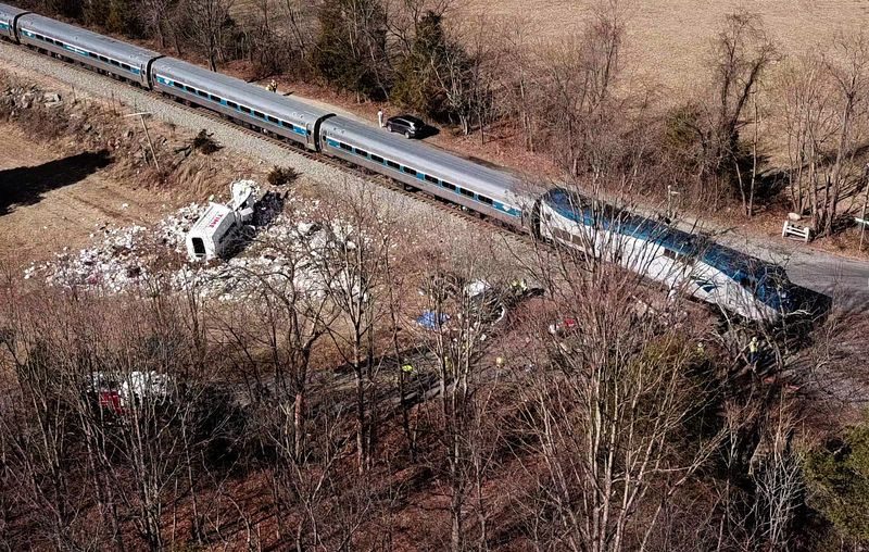 © Reuters. The wreckage of a garbage truck lies beside an Amtrak passenger train after a collision in Crozet