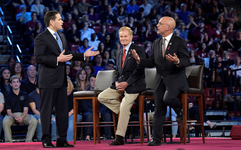 © Reuters. Senator Marco Rubio and Congressman Ted Deutch disagree during a CNN town hall meeting, at the BB&T Center, in Sunrise