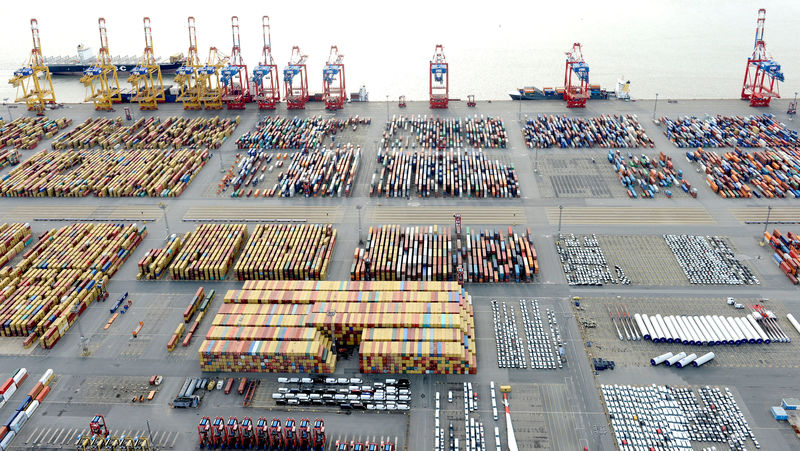 © Reuters. FILE PHOTO: Cars and containers are pictured at a shipping terminal in the harbour of the German northern town of Bremerhaven