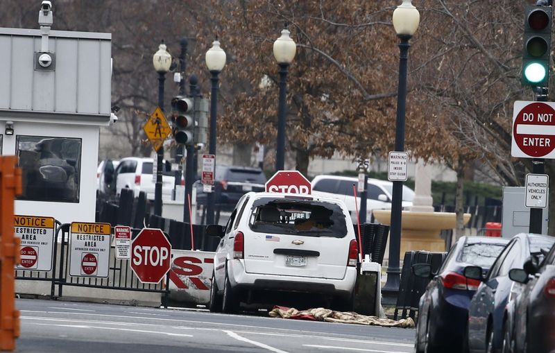 © Reuters. A passenger vehicle that struck a security barrier sits near the White House in Washington