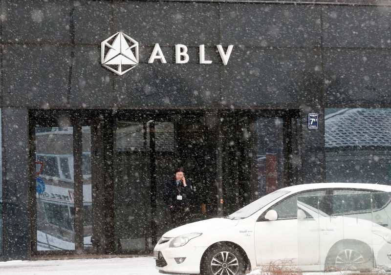 © Reuters. A security guard speaks on her mobile phone at the head office of the ABLV Bank