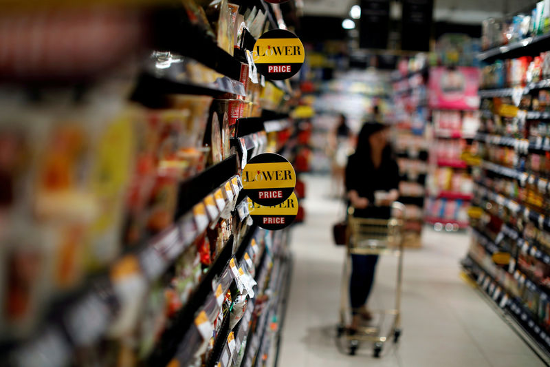 © Reuters. FILE PHOTO: Golden baskets and shopping carts are seen inside the Gourmet Market supermarket in Bangkok