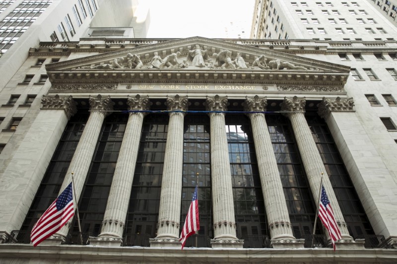 © Reuters. FILE PHOTO: U.S. flags hang outside of the New York Stock Exchange in New York