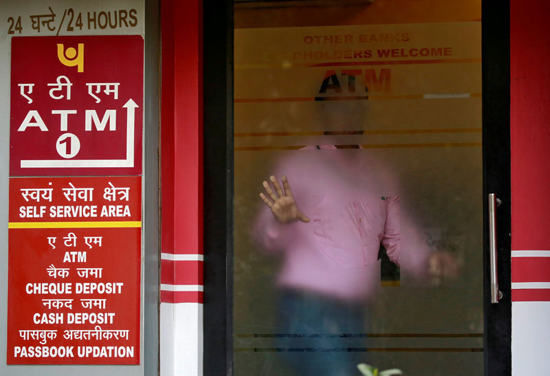 © Reuters. FILE PHOTO: A man leaves an automated teller machine facility of Punjab National Bank in New Delhi