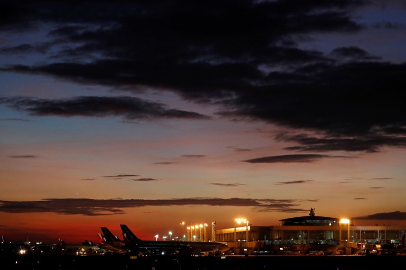 © Reuters. FILE PHOTO: Planes sit at the terminal as the sun sets at Ninoy-Aquino International Airport in Manila, Philippines