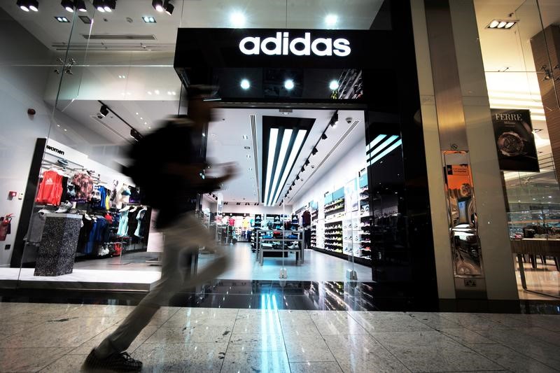 © Reuters. A boy is seen running in front of the Adidas store at Bahrain City Center in Manama