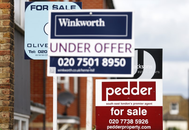 © Reuters. Signs advertising homes, sold, for sale and under offer, are seen on a road in south London