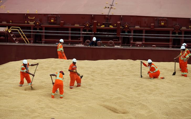 © Reuters. Trabalhos trabalhando em navio de carga com soja enviada à China, no porto de Santos, Brasil