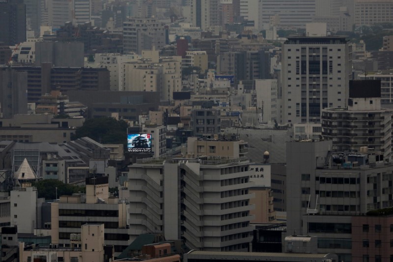 © Reuters. FILE PHOTO: Billboard advertising a car is seen in central Tokyo