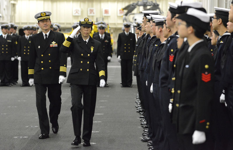 © Reuters. Newly-appointed Commander of First Escort Division of JMSDF Ryoko Azuma salutes to soldiers in Yokohama