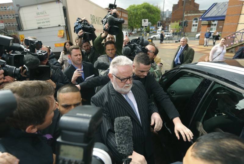 © Reuters. FILE PHOTO: Paul Flowers the former chairman of the Co-operative Bank leaves Leeds Magistrates' Court in Northern England