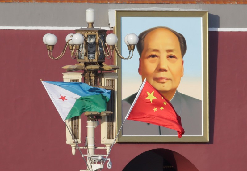 © Reuters. Djibouti and Chinese national flags are seen in front of the portrait of China's late Chairman Mao Zedong at Tiananmen Square, ahead of a welcoming ceremony for Djibouti's President Ismail Omar Guelleh, in Beijing