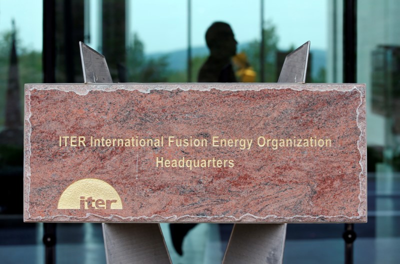 © Reuters. A man walks past a block of stone with the name of the International Thermonuclear Experimental Reactor (ITER) organization headquarters in Saint-Paul-lez-Durance